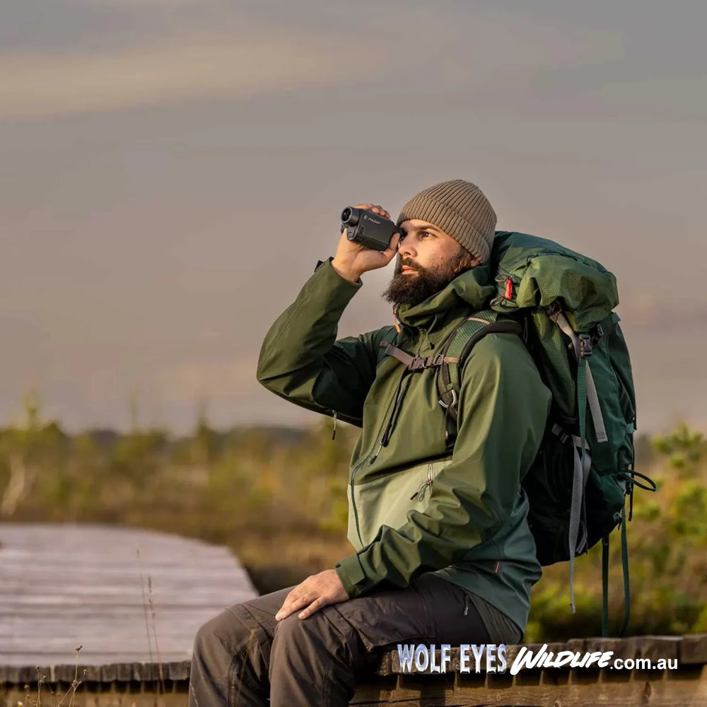 man on wildlife eco boardwalk scanning with Pulsar Wildlife Alaris XG30 XQ30 thermal monocular Australia